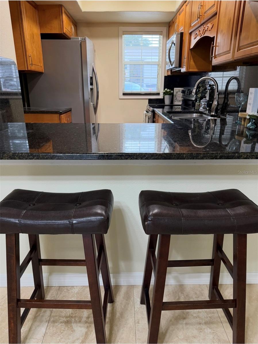The Kitchen has an opening and bar space to the living room where 2-3 stools can go.