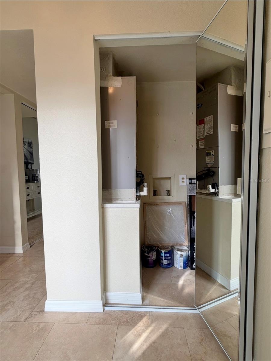 This is a hallway closet that houses the Air Handler, the hot water heater, and has storage space.