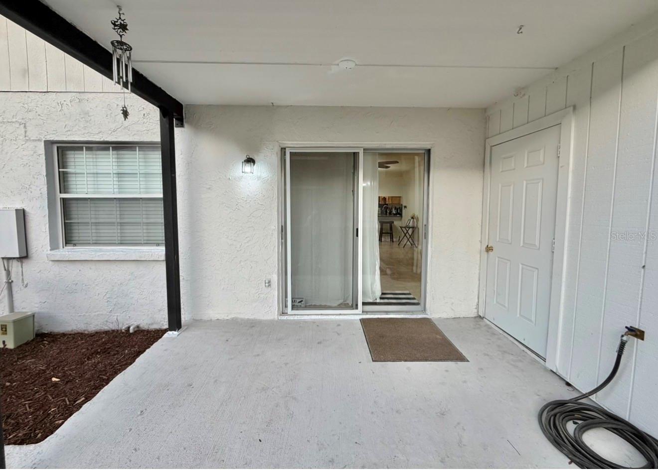 The back porch is a great place to hang out, and it's already wired for a ceiling fan. There's a utility closet and a hose & spigot.