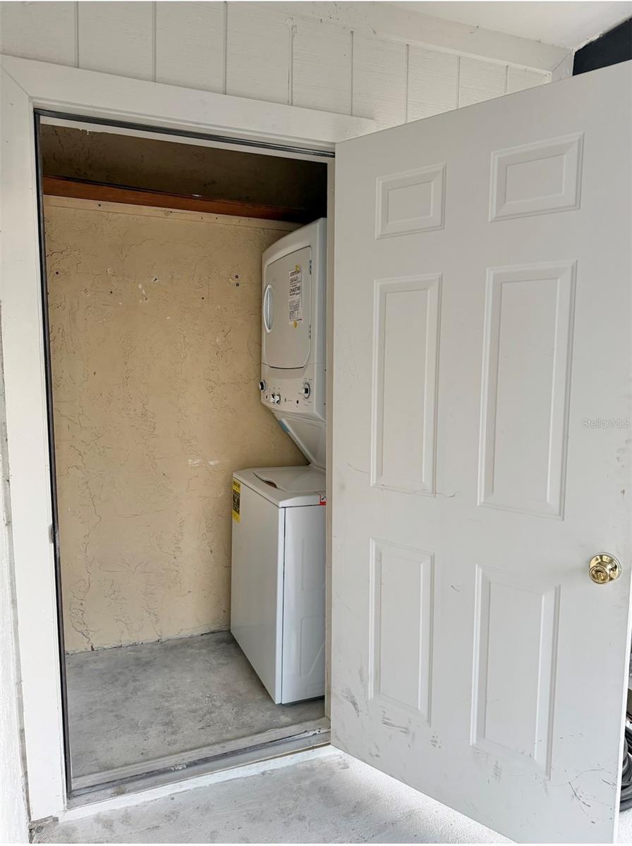 Utility Room with a brand new washer & dryer set are under cover off the back porch.