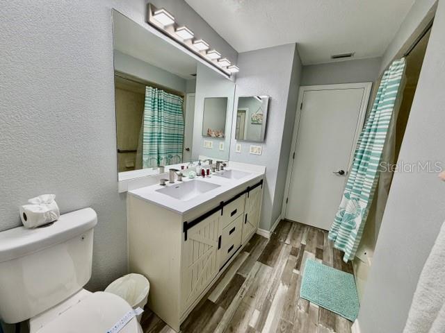 guest bathroom with shower/tub ad pool door entrance.