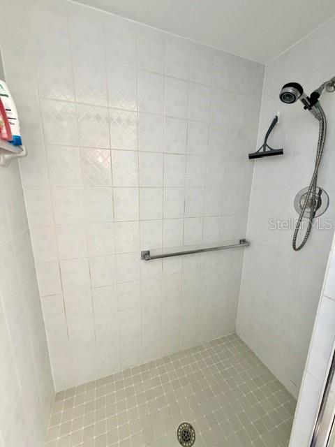 primary ceramic tiled walk-in shower