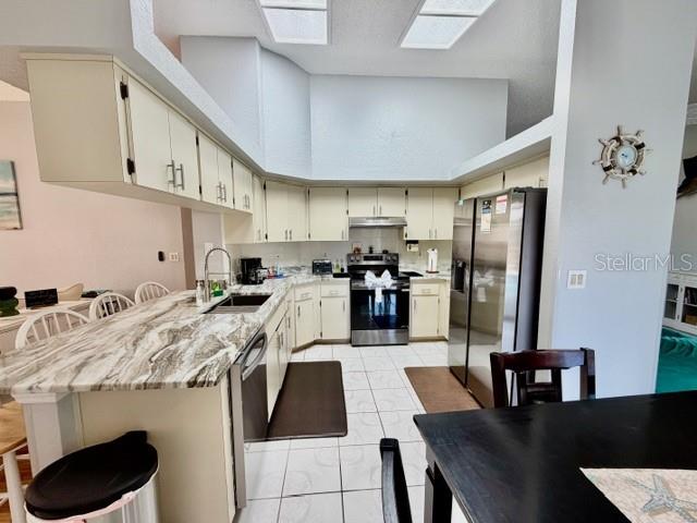 updated kitchen with granite countertops , stainless steel range, and brand new refrigerator and disshwasher