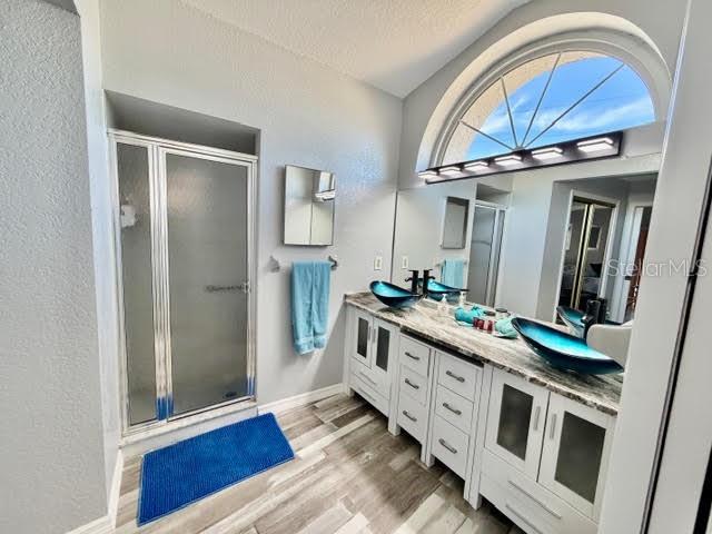 Primary ensuite bathroom with new stunning dual granite counter tops and bowl sinks, private walk-in shower and private toilet room