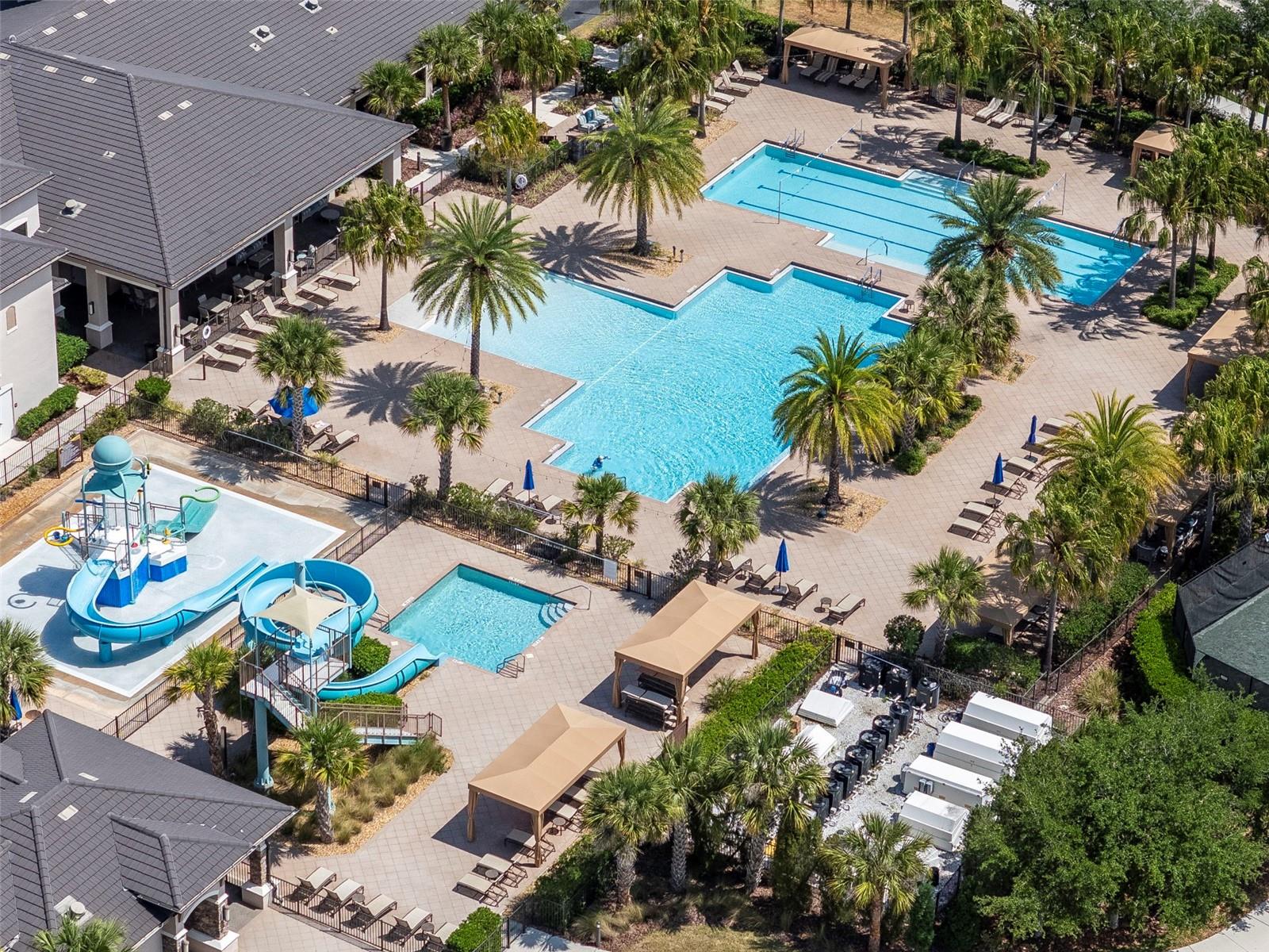 Aerial view of 3 pools, slide, and splash playground