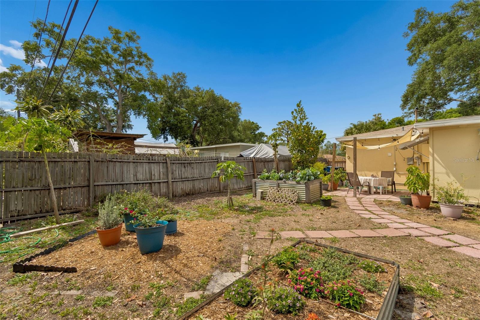 A gardener's paradise with fruit trees and raised garden beds