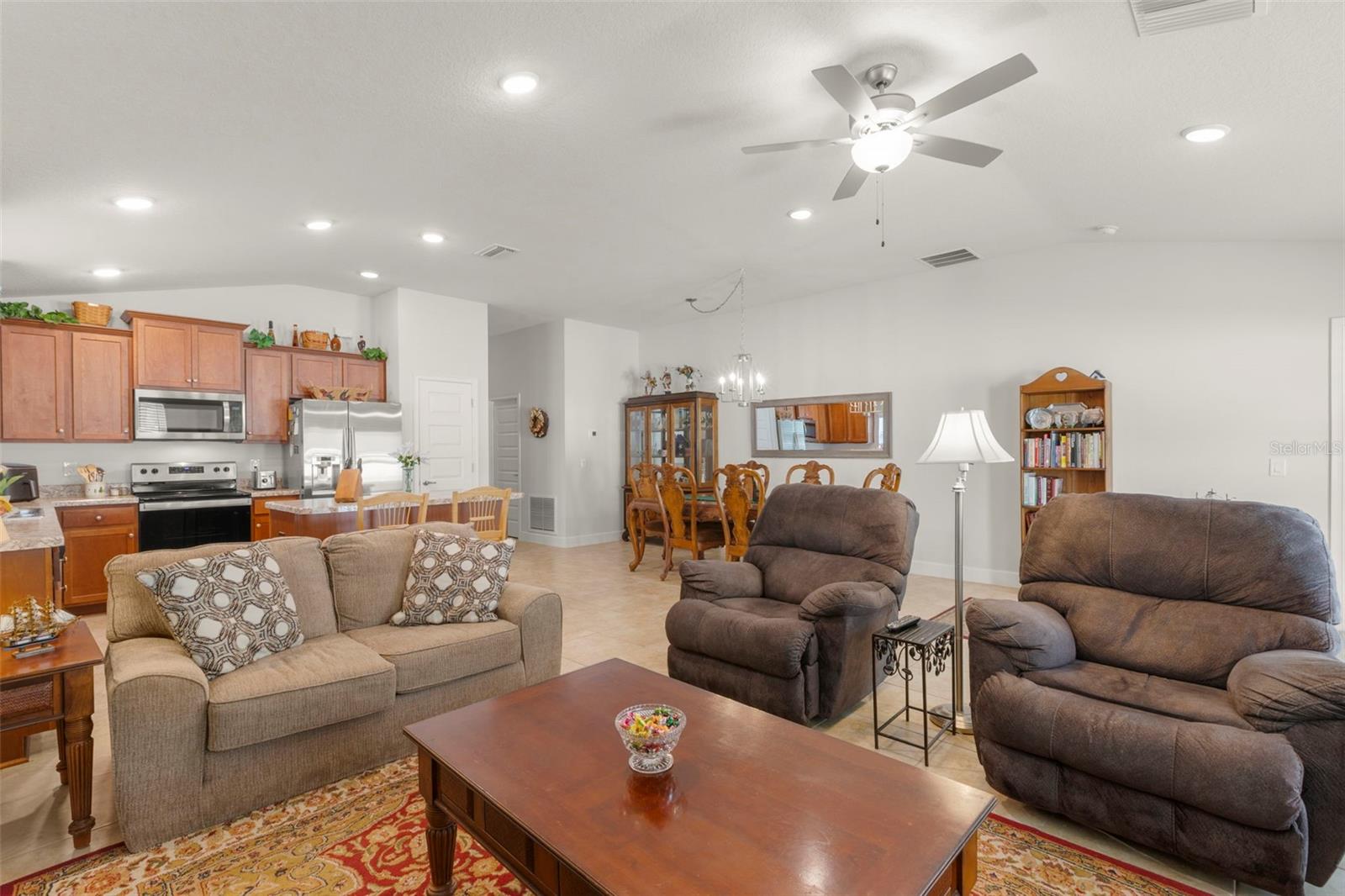 Expansive open-concept living spaces offer exceptional flexibility for both casual gathering and formal dining, with seamless flow between the living room, dining area, and kitchen.