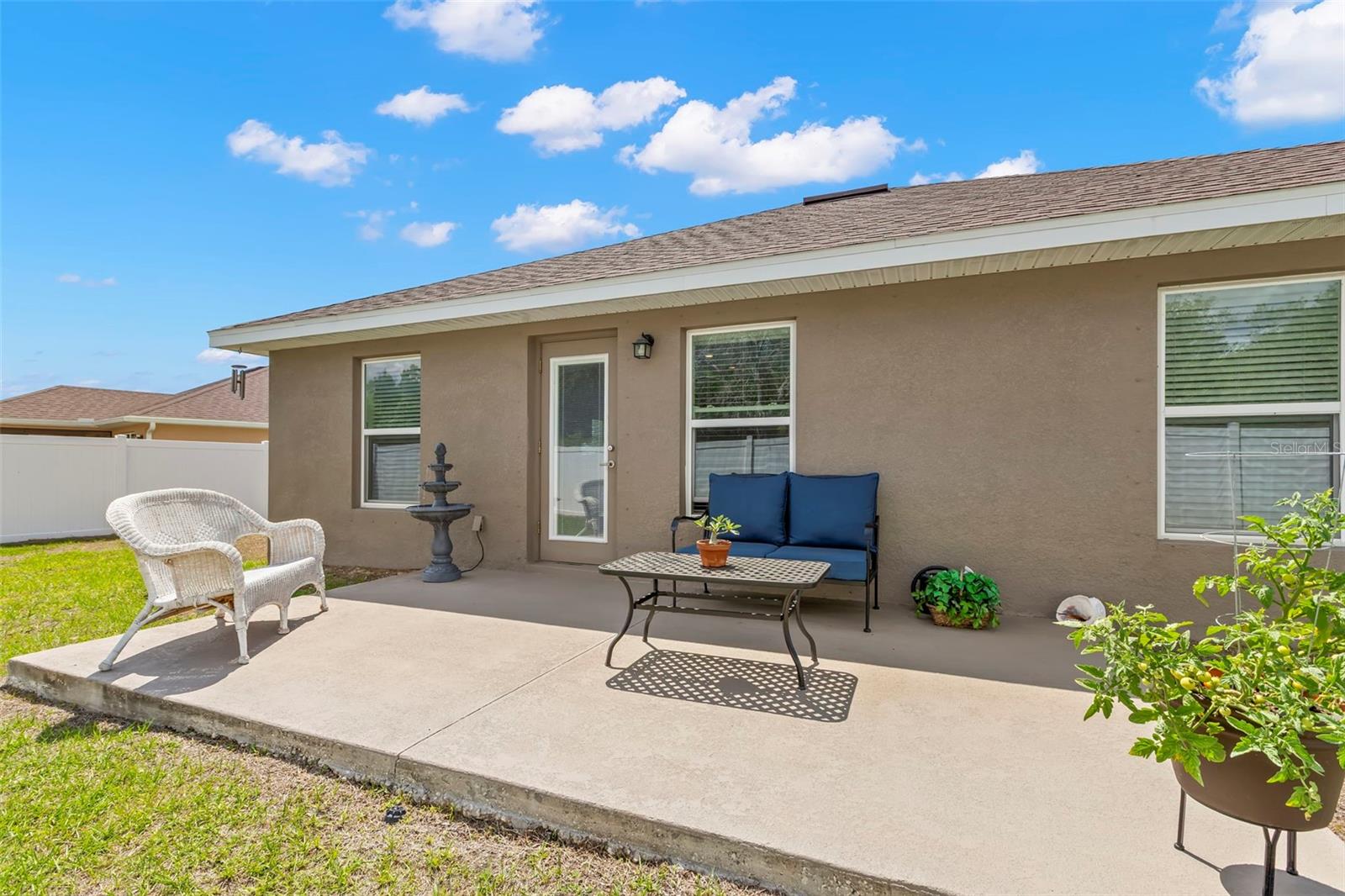 Step outside to a spacious rear patio overlooking the oversized fenced backyard—an ideal setting for outdoor dining, morning coffee, or relaxed evening gatherings.