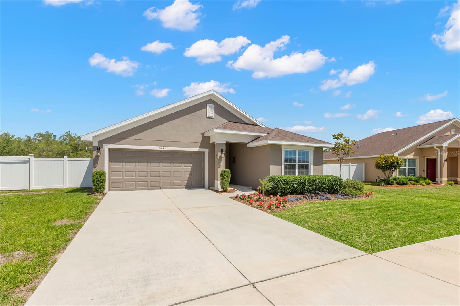Additional bird’s-eye view showcases the home’s premium lot placement, expansive fenced yard, and private wooded backdrop.