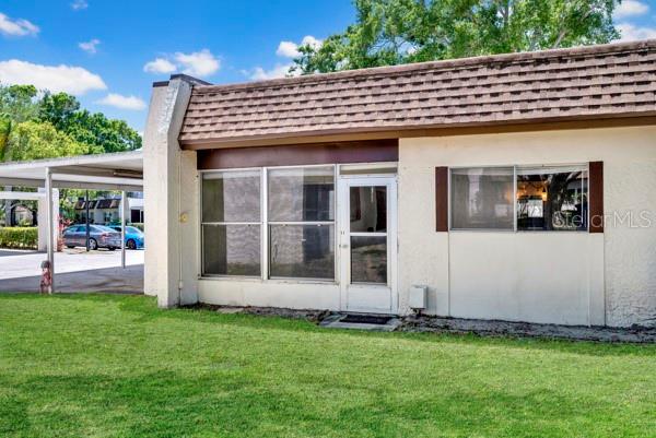 OUTSIDE VIEW OF SIDE AND CARPORT