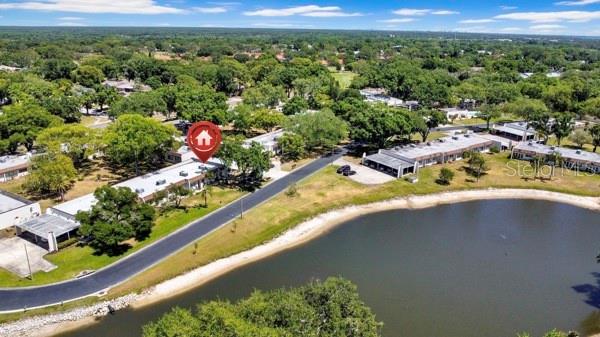 AERIAL VIEW OF CONDO WITH POND