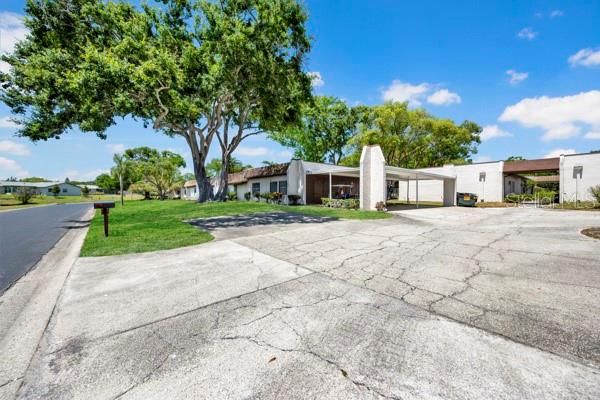 FRONT WITH DRIVEWAY AND CARPORT