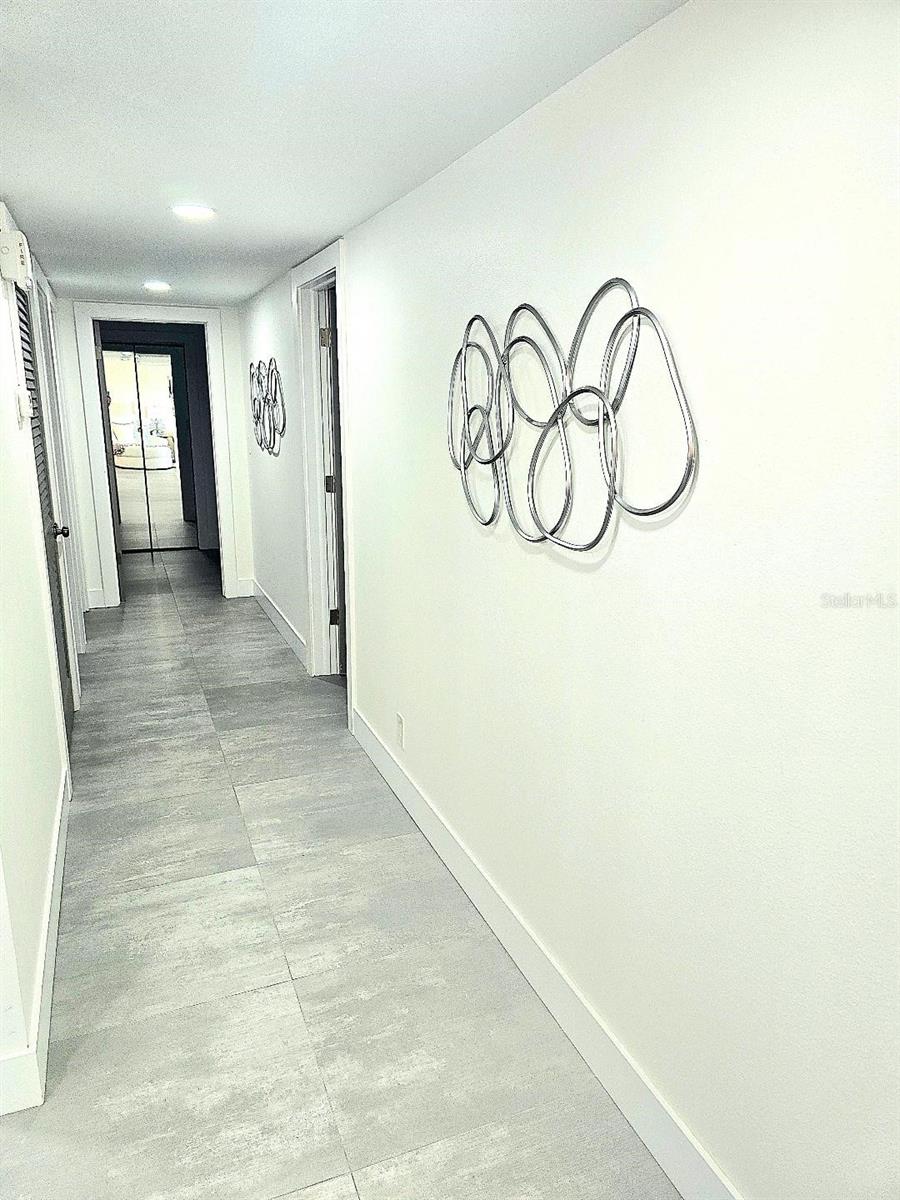 Hallway to bedrooms, storage and baths.