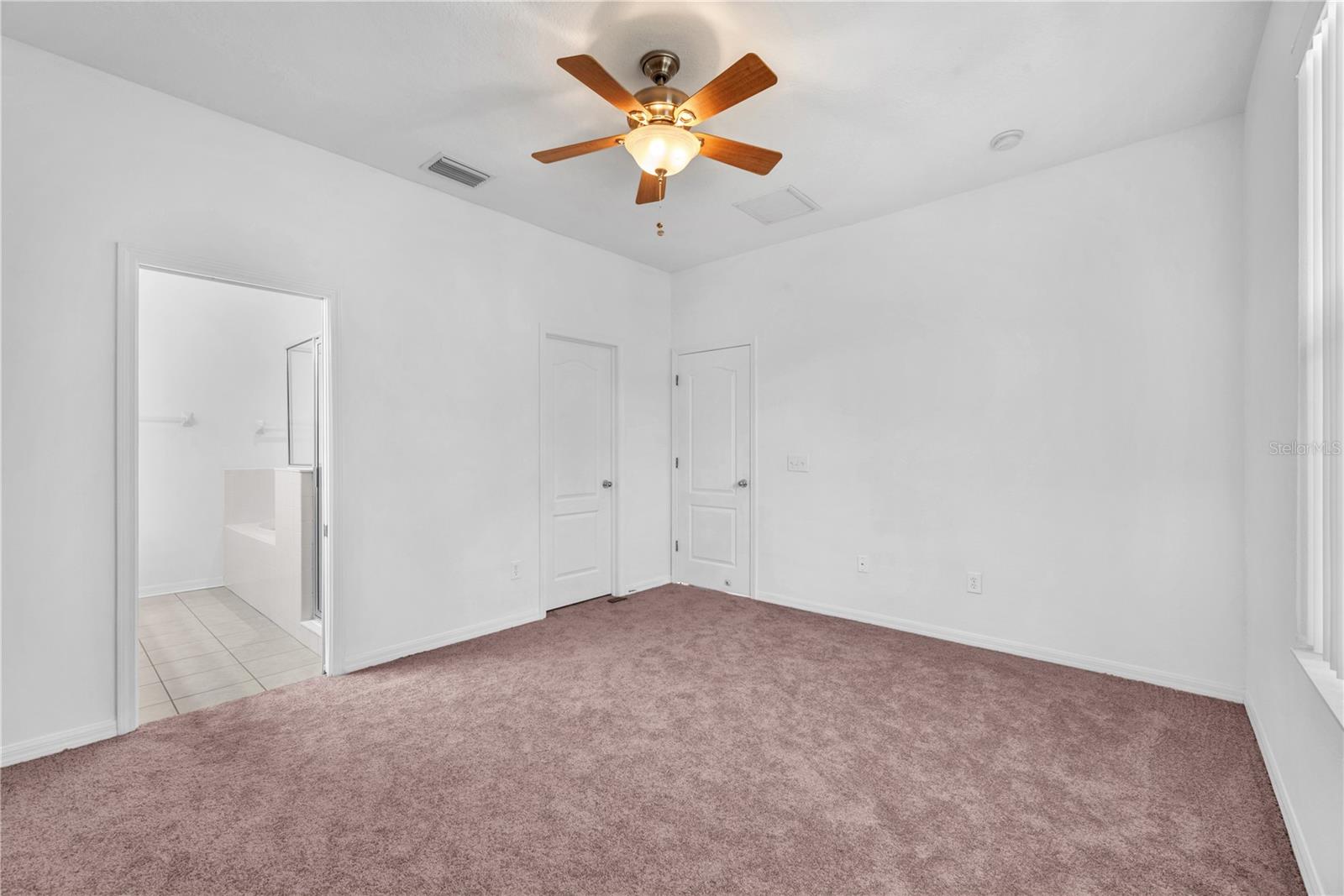 The primary suite has a spacious walk-in closet and a spa-inspired en-suite bath.