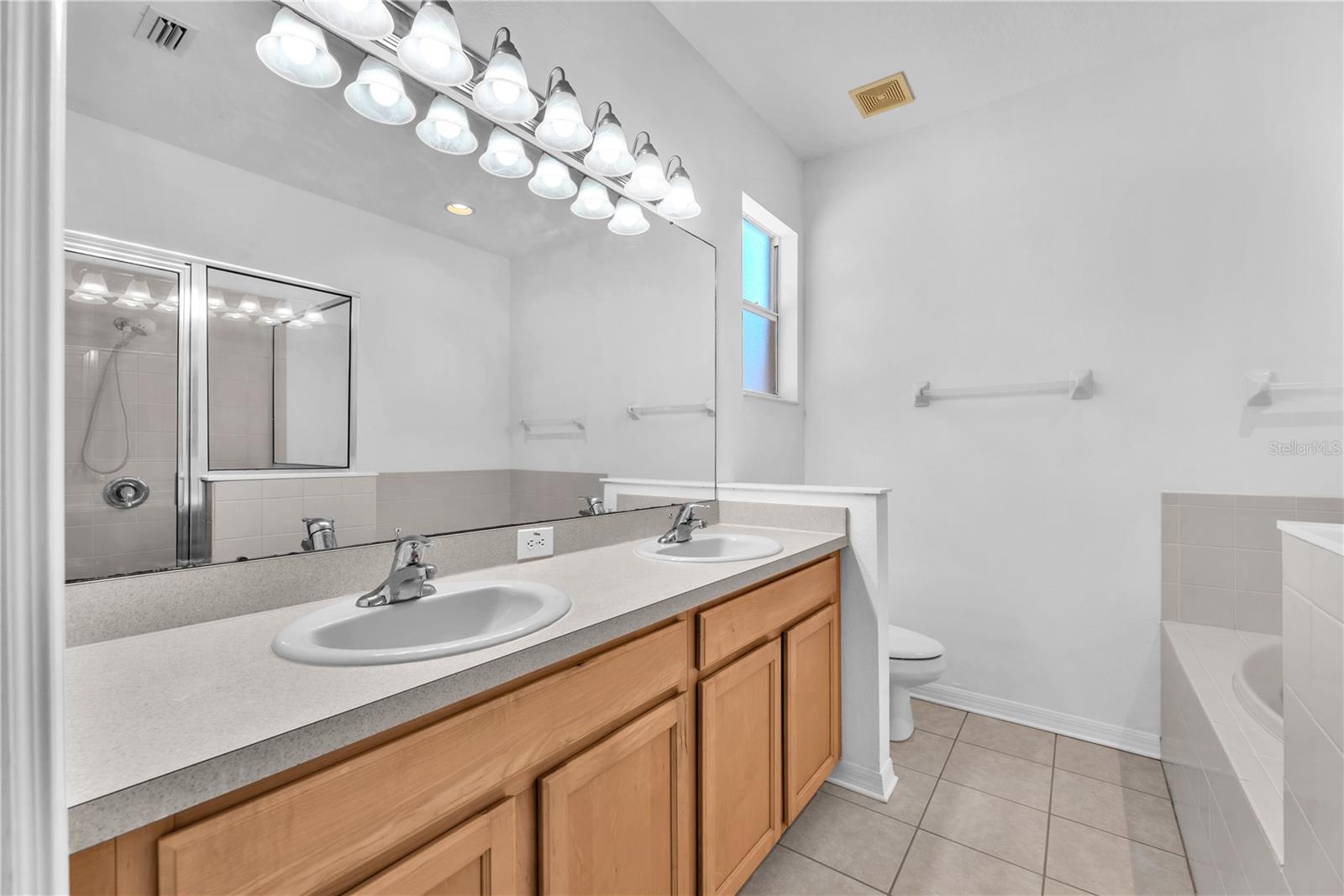 The owner’s bathroom features an extended dual-sink vanity with ample space to make busy mornings easier.
