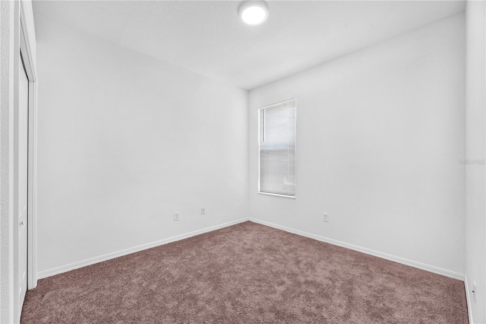 Secondary bedroom #3 with built-in closet, carpet and ceiling fan is 10' x 13'