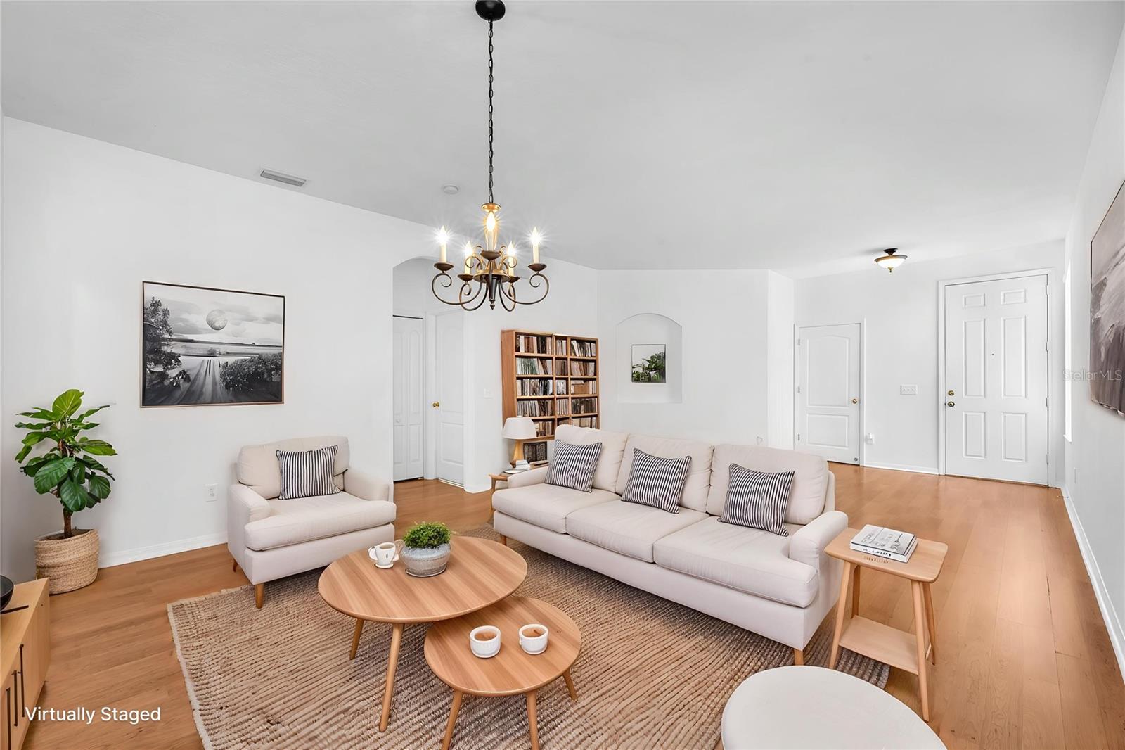 The hallway to the secondary bedrooms and guest bathroom is located off the living room, while access to the garage is through the laundry room just next to the front door.