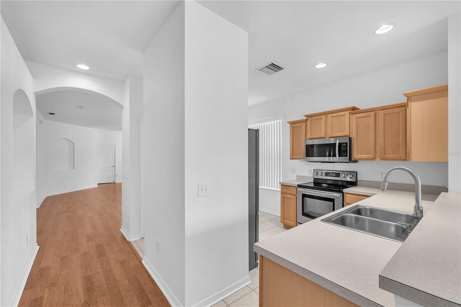 The kitchen is open to the family room and separated room the living/dining room