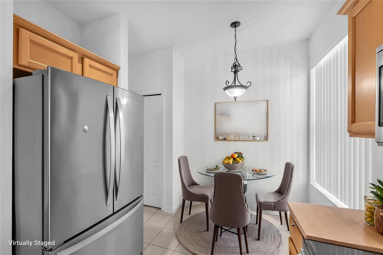 The kitchen features stainless steel appliances, a closet pantry and a bright eat-in dining space.