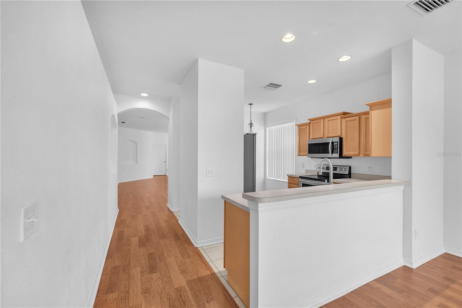 The breakfast bar provides extra seating and is open to the family room.