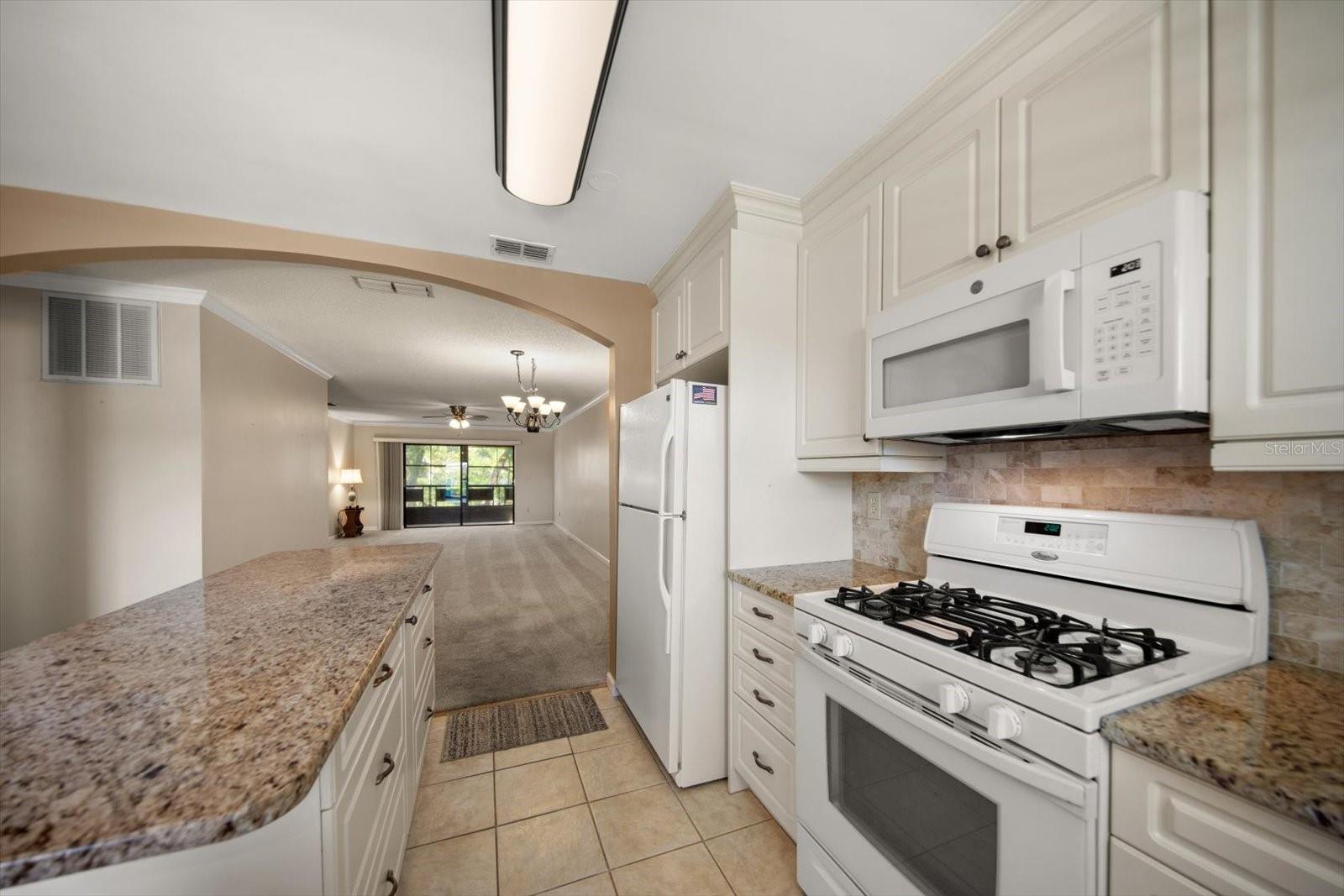 Island has lot of drawers for storage and great view to the living room and out to the porch