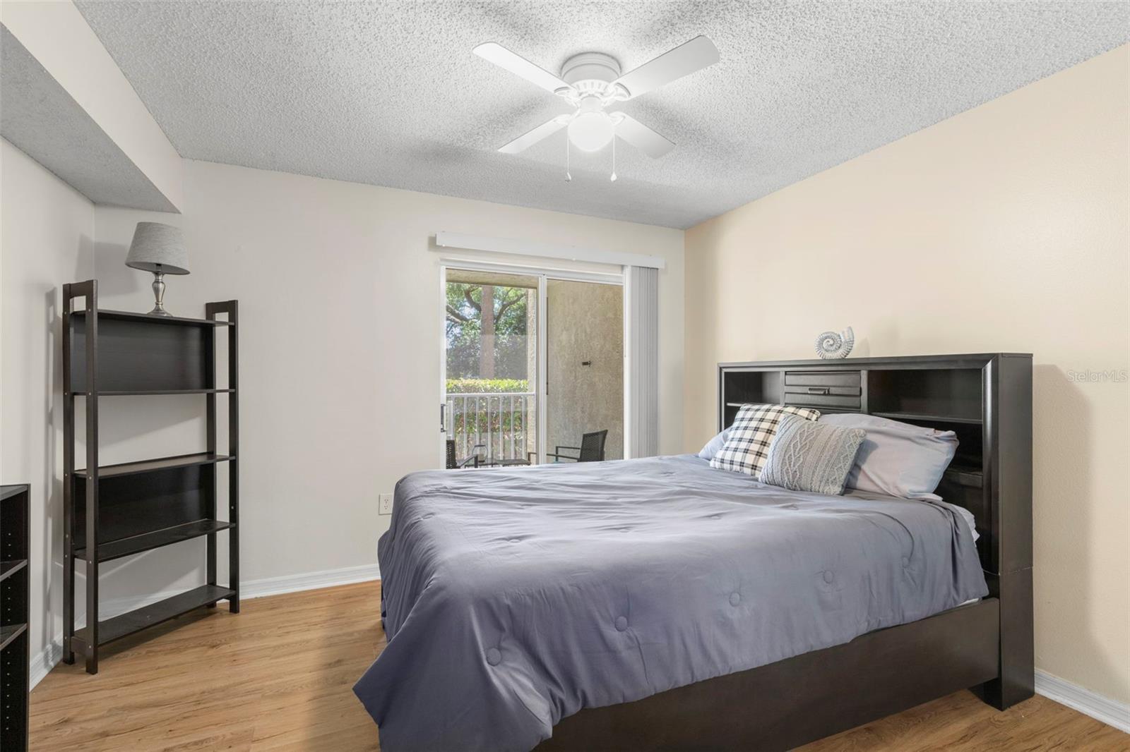 Primary bedroom with entrance to screened Primary bedroom with entrance to screened patio
