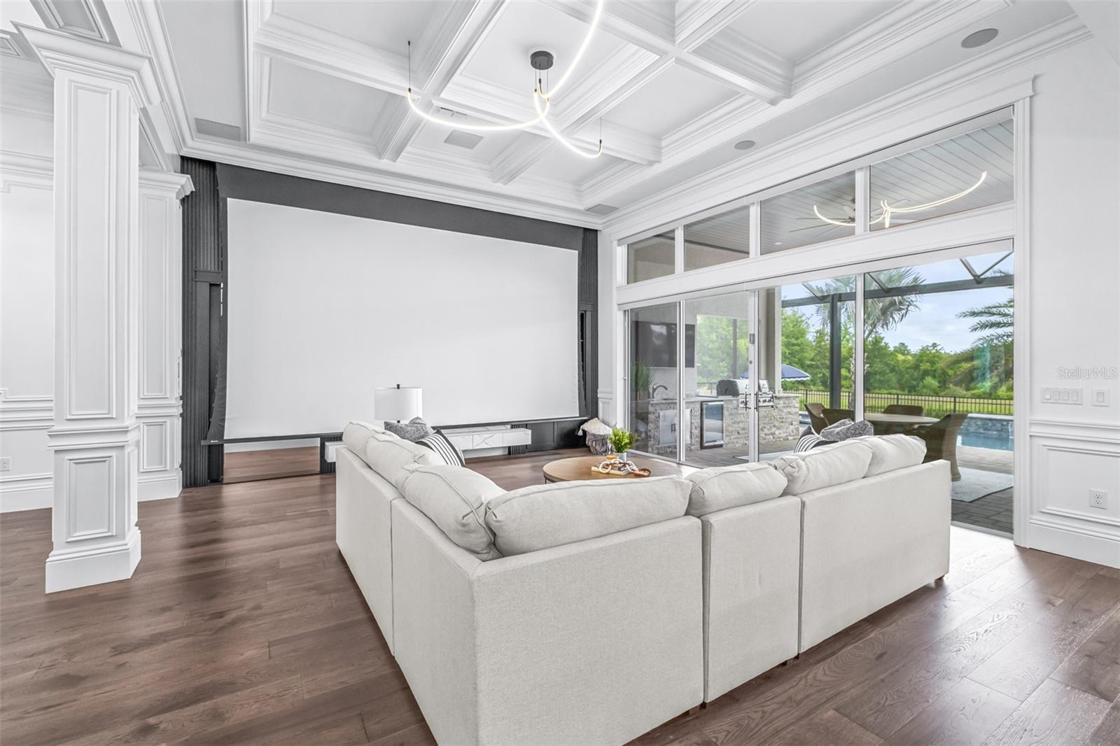 The 220" Drop-Down Screen, Built-in Projector, and Top of the Line Surround Sound Transform the Living Room into Your Own Personal Home Theater
