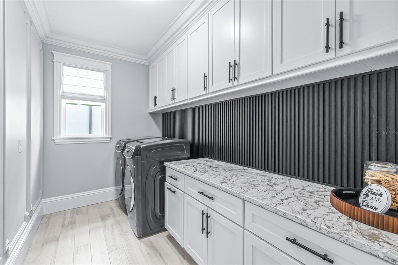 Massive Laundry Room with Ample Cabinets
