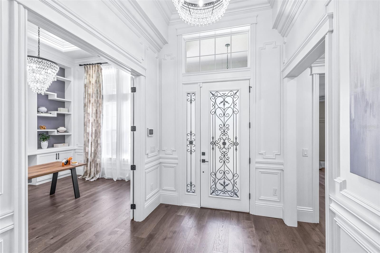 Grand Entryway with Custom Poplar Trim where Chandeliers Adorn Soaring Ceilings