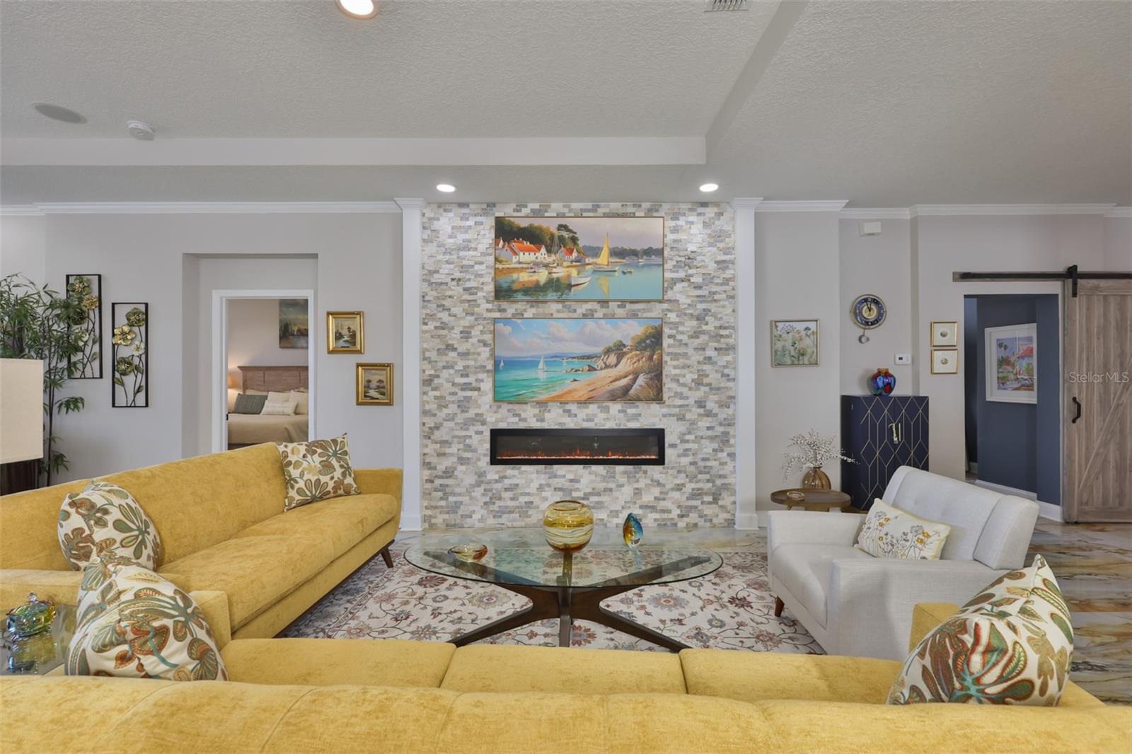 The accent wall is understated with a touch of elegance in lighting.  A centerpiece of the room.