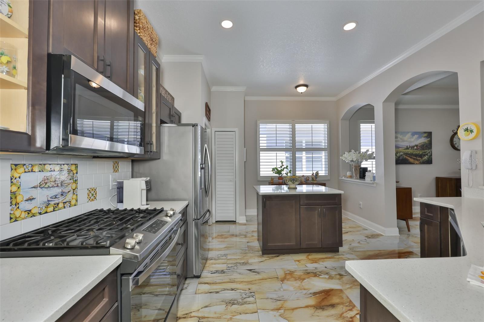 The kitchen boasts of a gas range, custom Italian tiles and newer appliances.