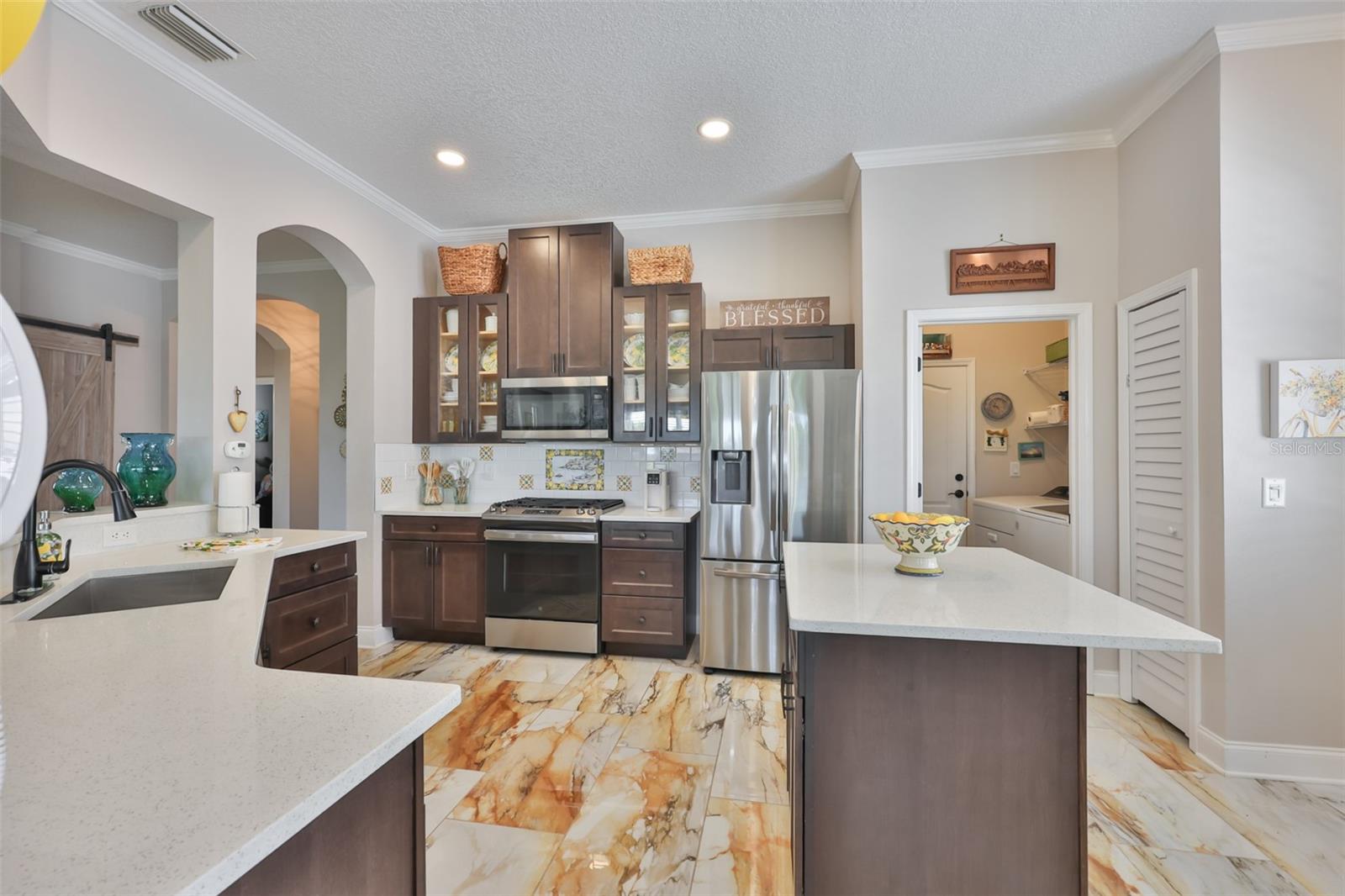 There is a large pantry and an island for additional counter space and storage.