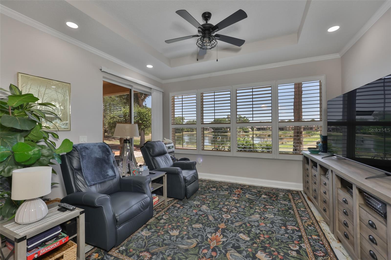 The "bonus room" nook is especially pleasing, as it offers a direct view of the water.  Notice the plantation shutters and sliding glass doors that feed into the the lanai, if desired.