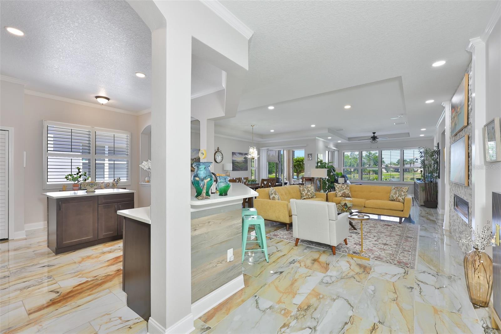 As you walk into the home, a stunning porcelain tile floor, open space and panorama of the water view welcome you home.