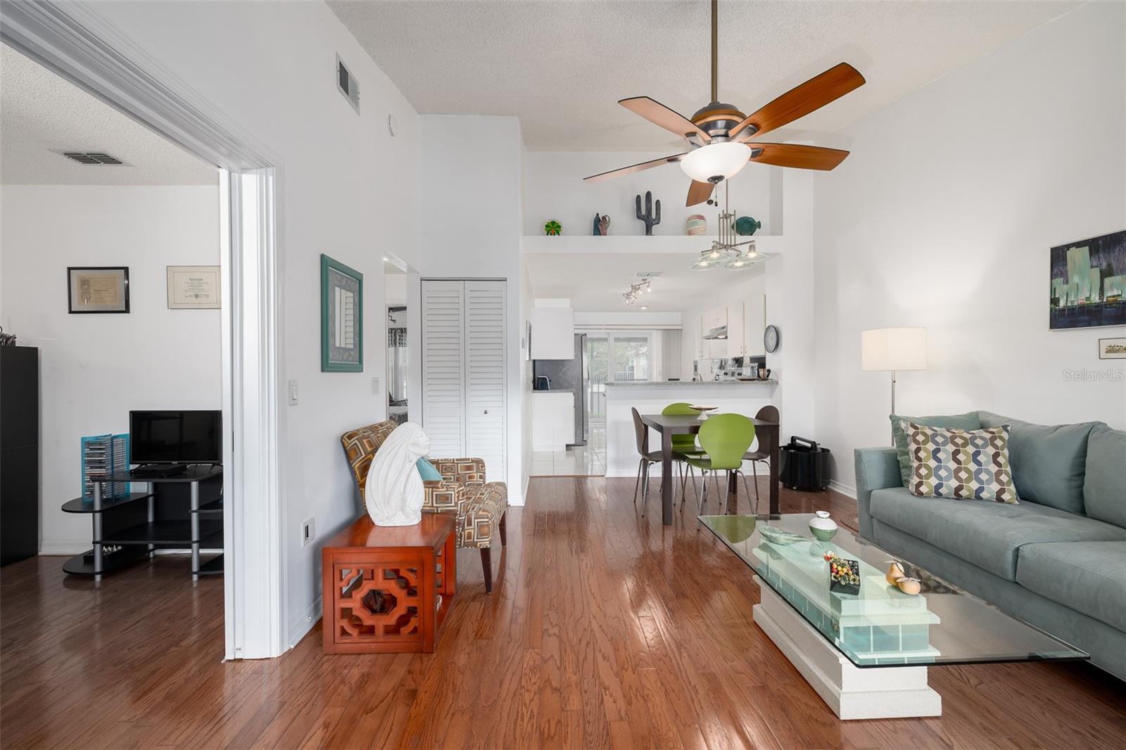 Entryway to living room, large den/office/2nd bedroom (w/out closet) to the left, dining area, kitchen, dinette, leading to glass sliding doors to patio.