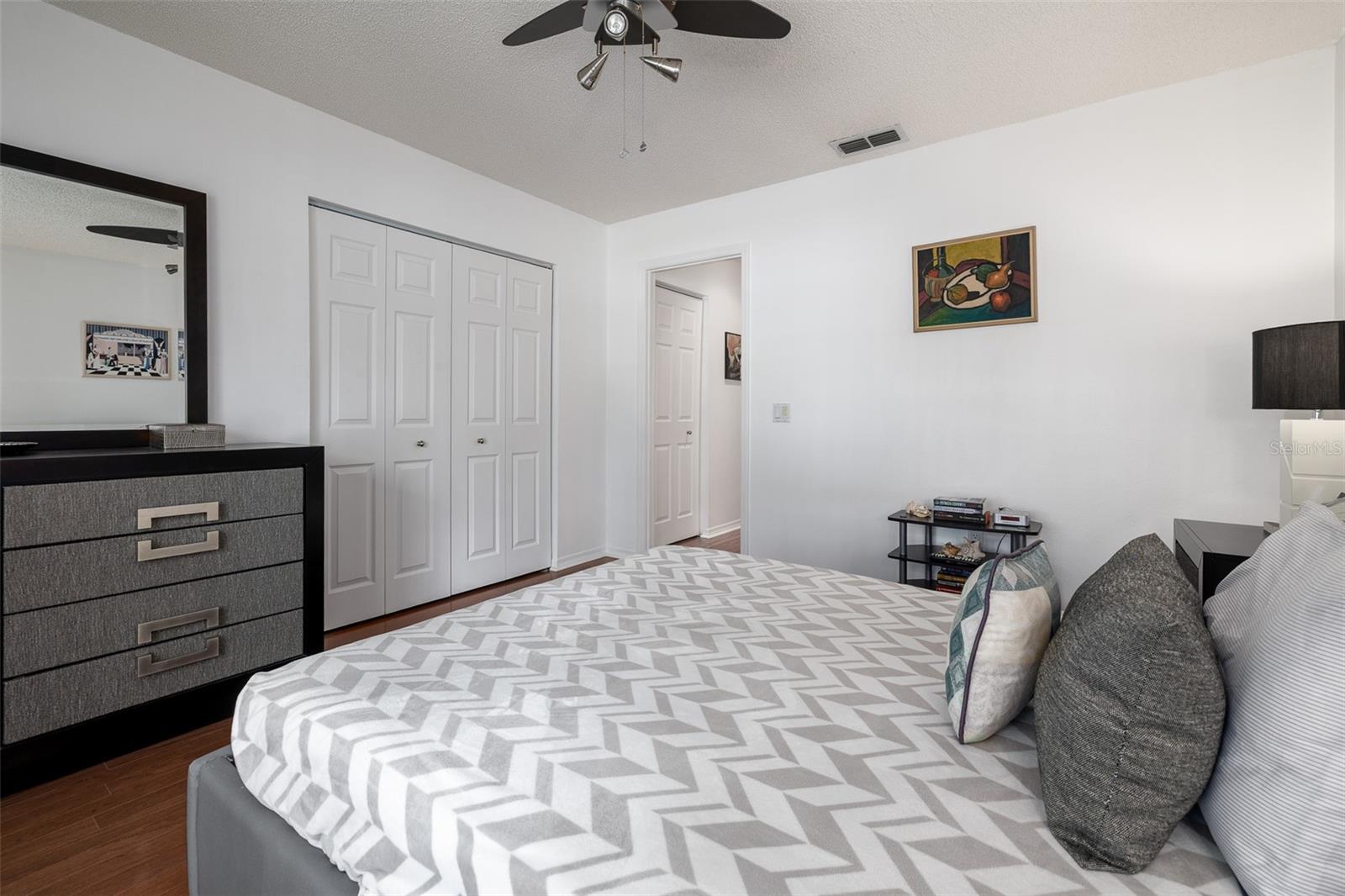 Owner's bedroom, ceiling fan, wood flooring