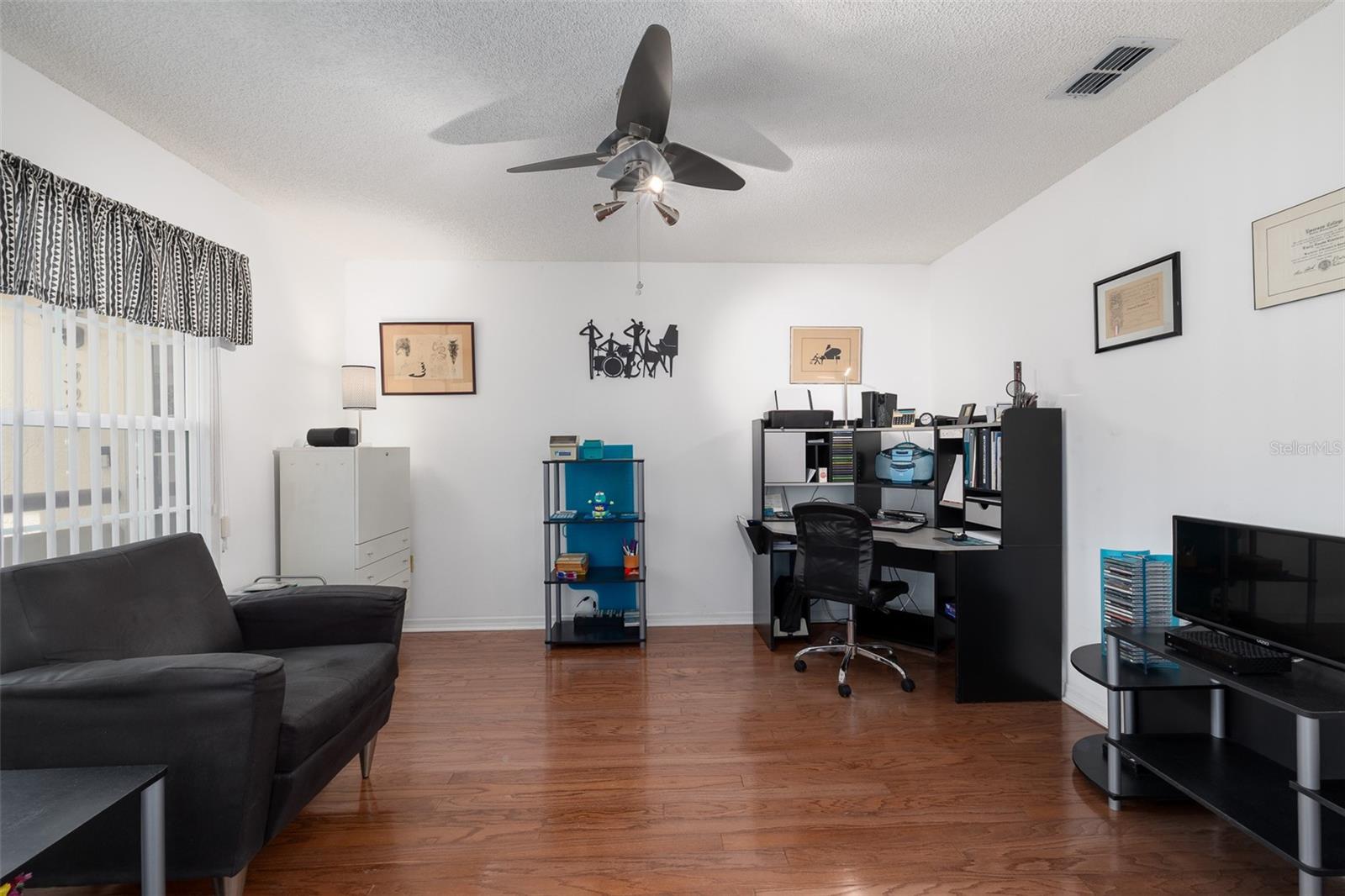 Large room to make a Den/Office/2nd Bedroom (w/out closet) plenty of room for a large armoire, wood flooring.