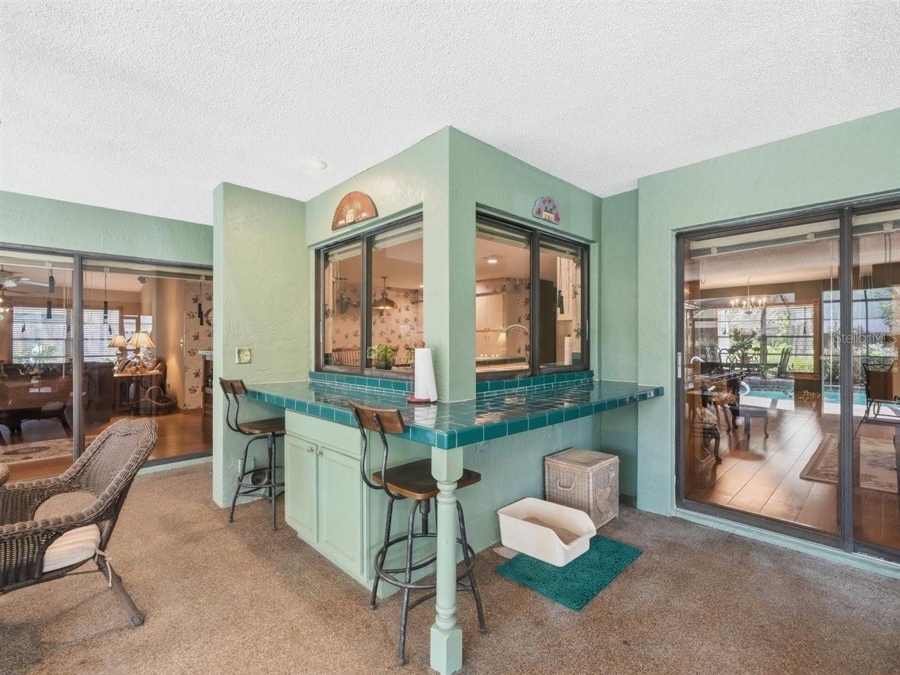 Bar and pass through windows to patio bar area
