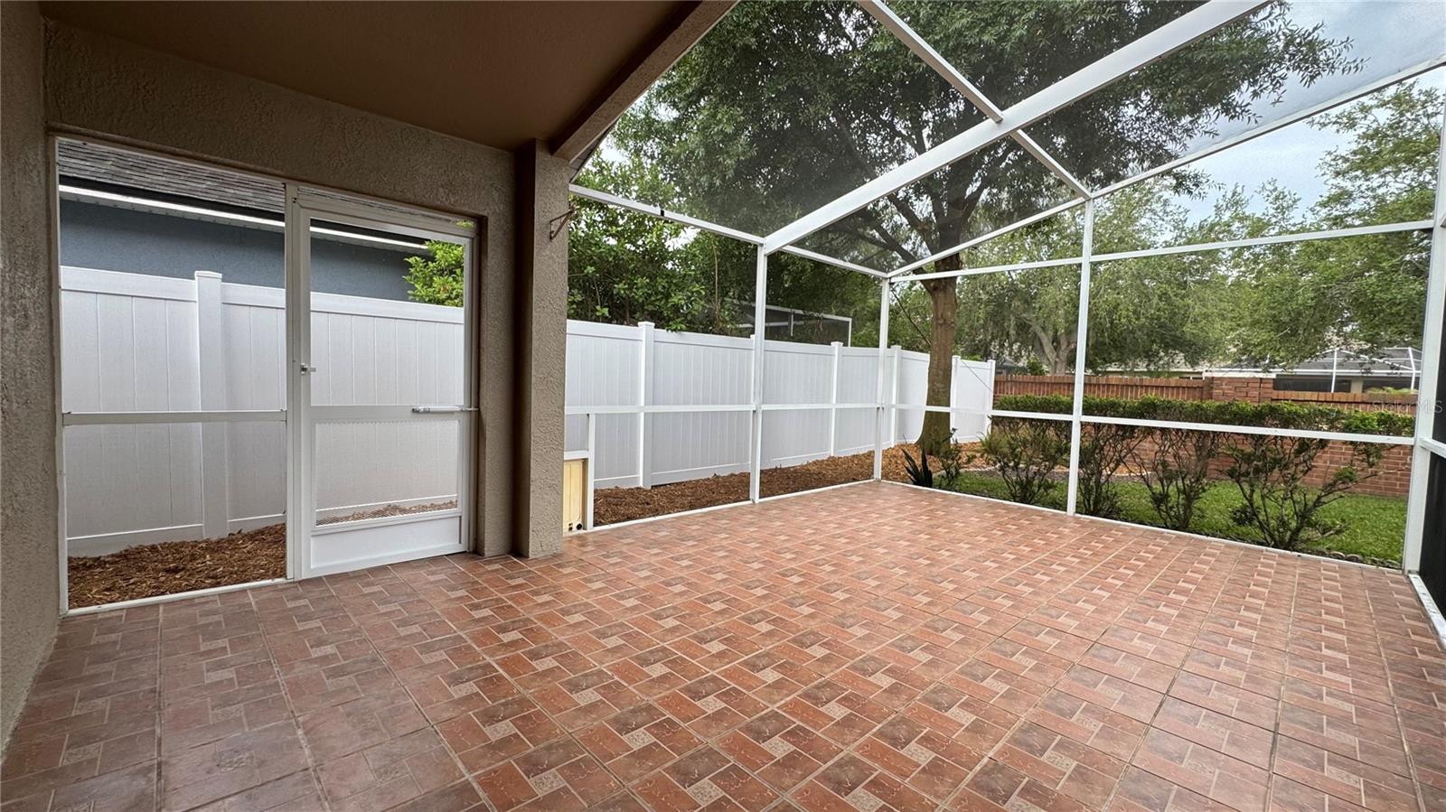 Wonderful 22' screened lanai with decorator ceramic tile floors, accessible from the family room and primary bedroom