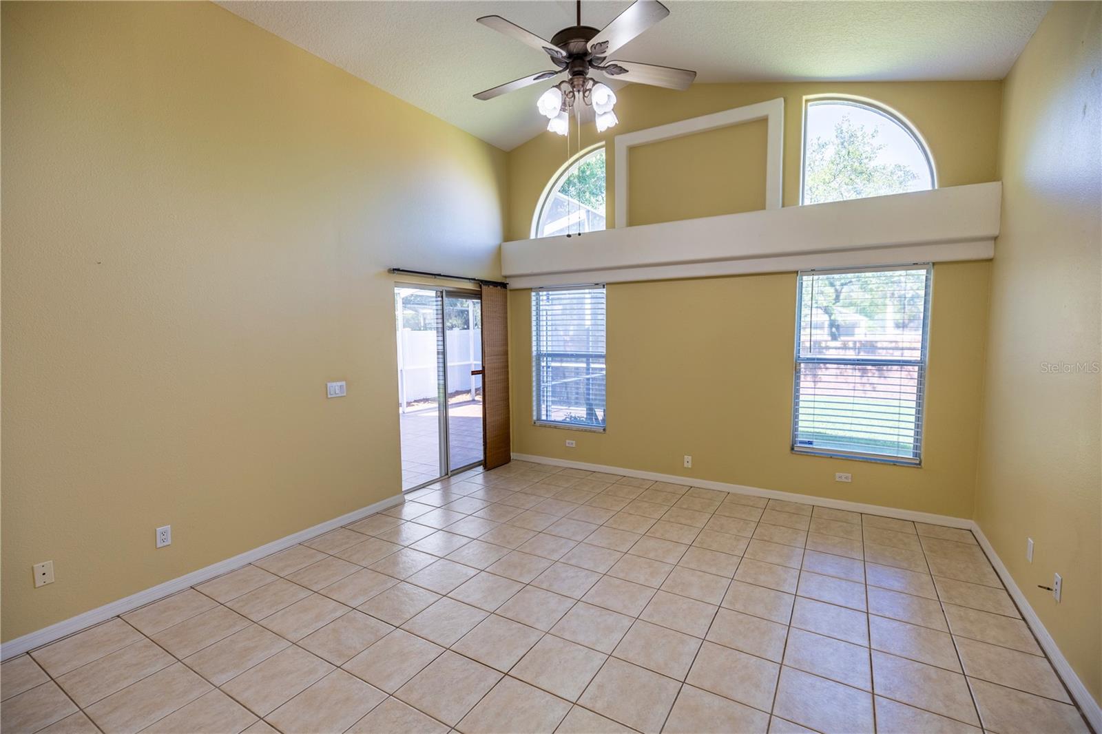 Family room with nice windows for lighting, high ceilings and sliders to screened lanai