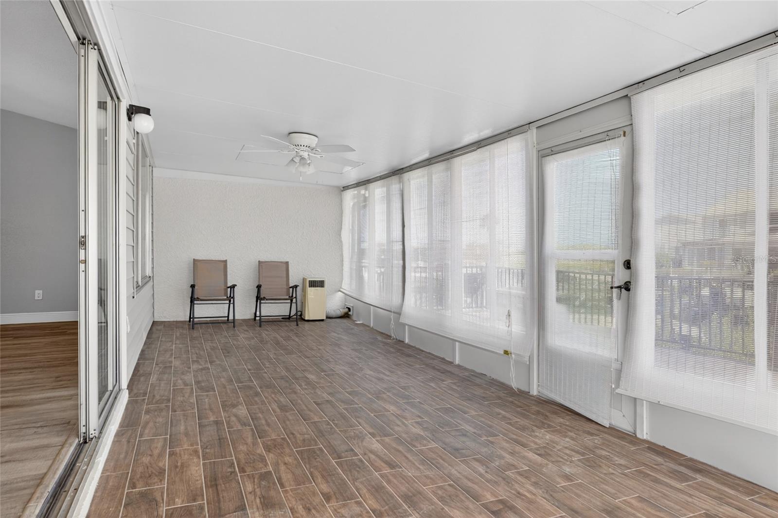 Enclosed sunroom overlooks the water.