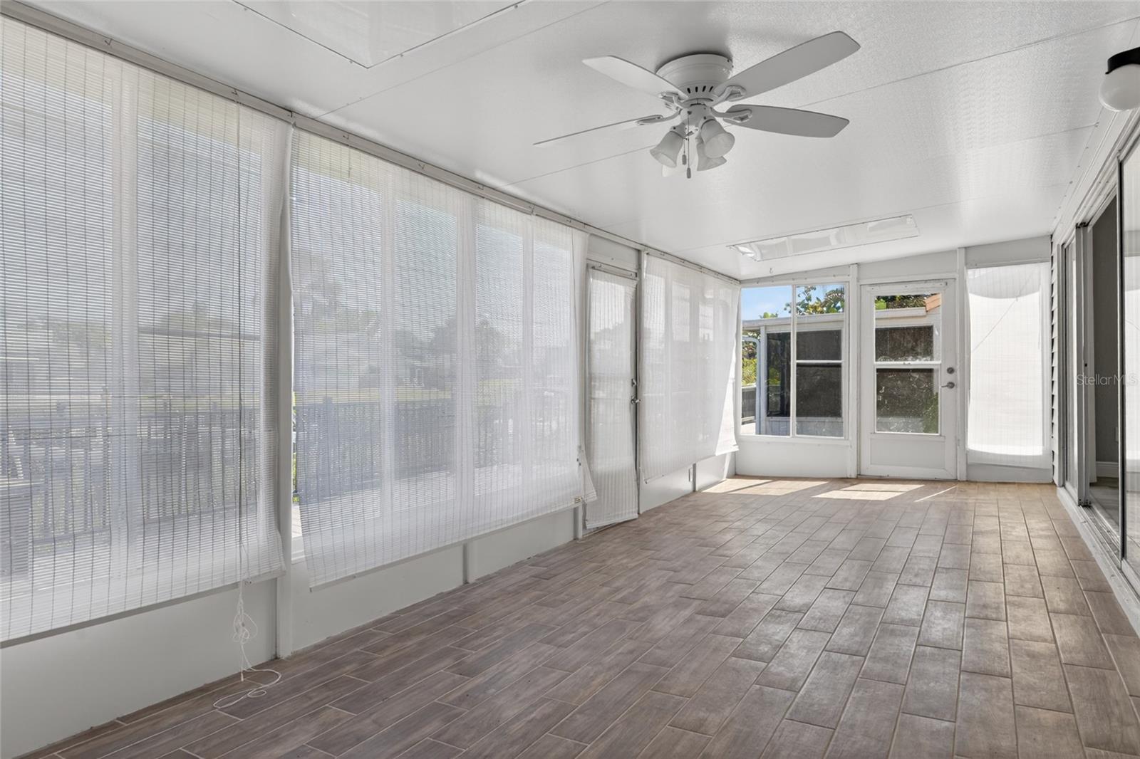 Enclosed sunroom with newer flooring.