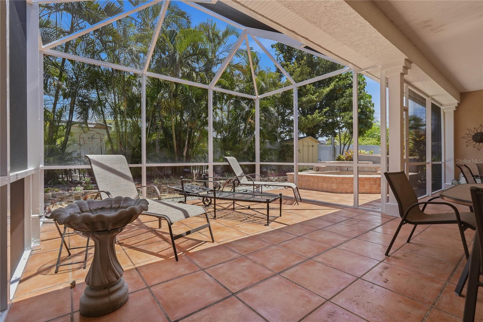 RELAX AND ENJOY THE SUNSHINE.  VINYL FENCING ENCIRCLES THE BEAUTIFUL MANICURED LANDSCAPING FEATURING MANY MATURE PALMS.