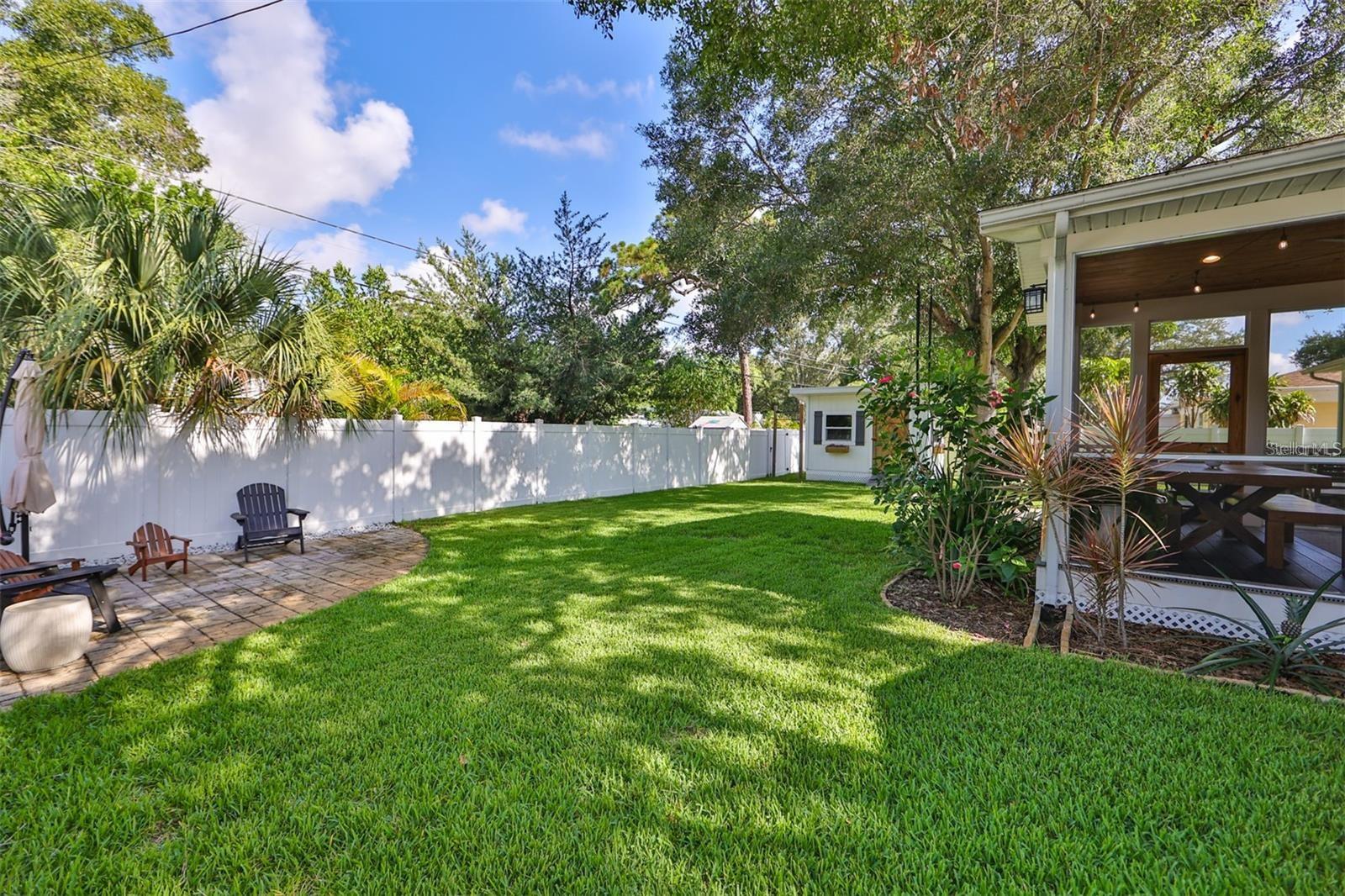 Backyard with fully enclosed vinyl fence.