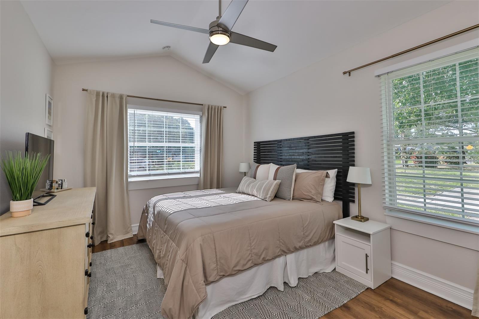 Master bedroom suite with tall cathedral ceilings and lots of natural light.