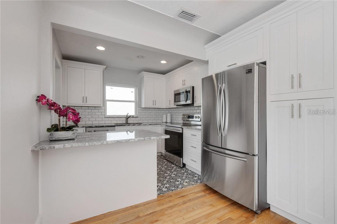 Kitchen bar creates a dynamic environment in living space.