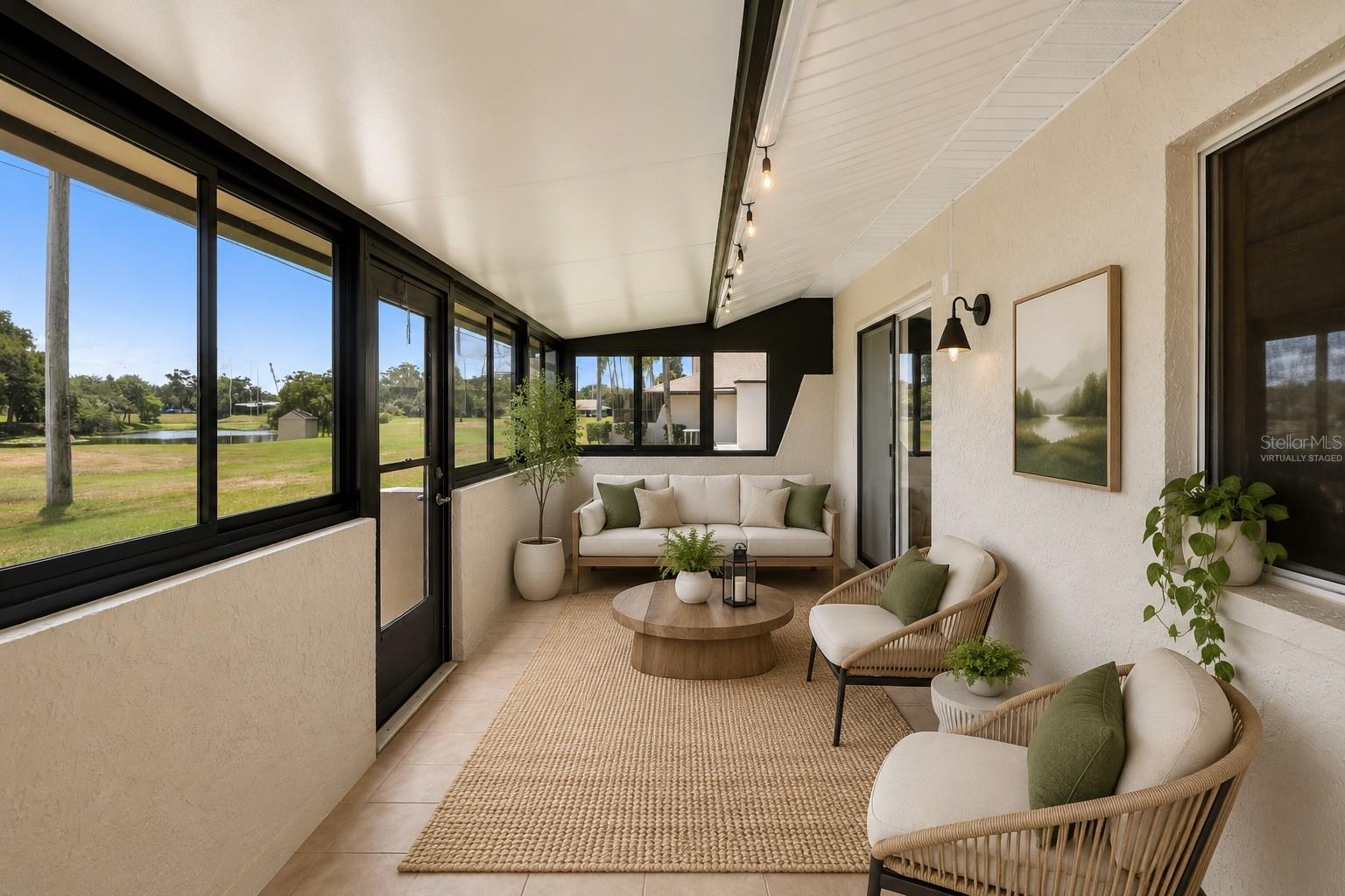 Virtually staged large rear porch with water views!