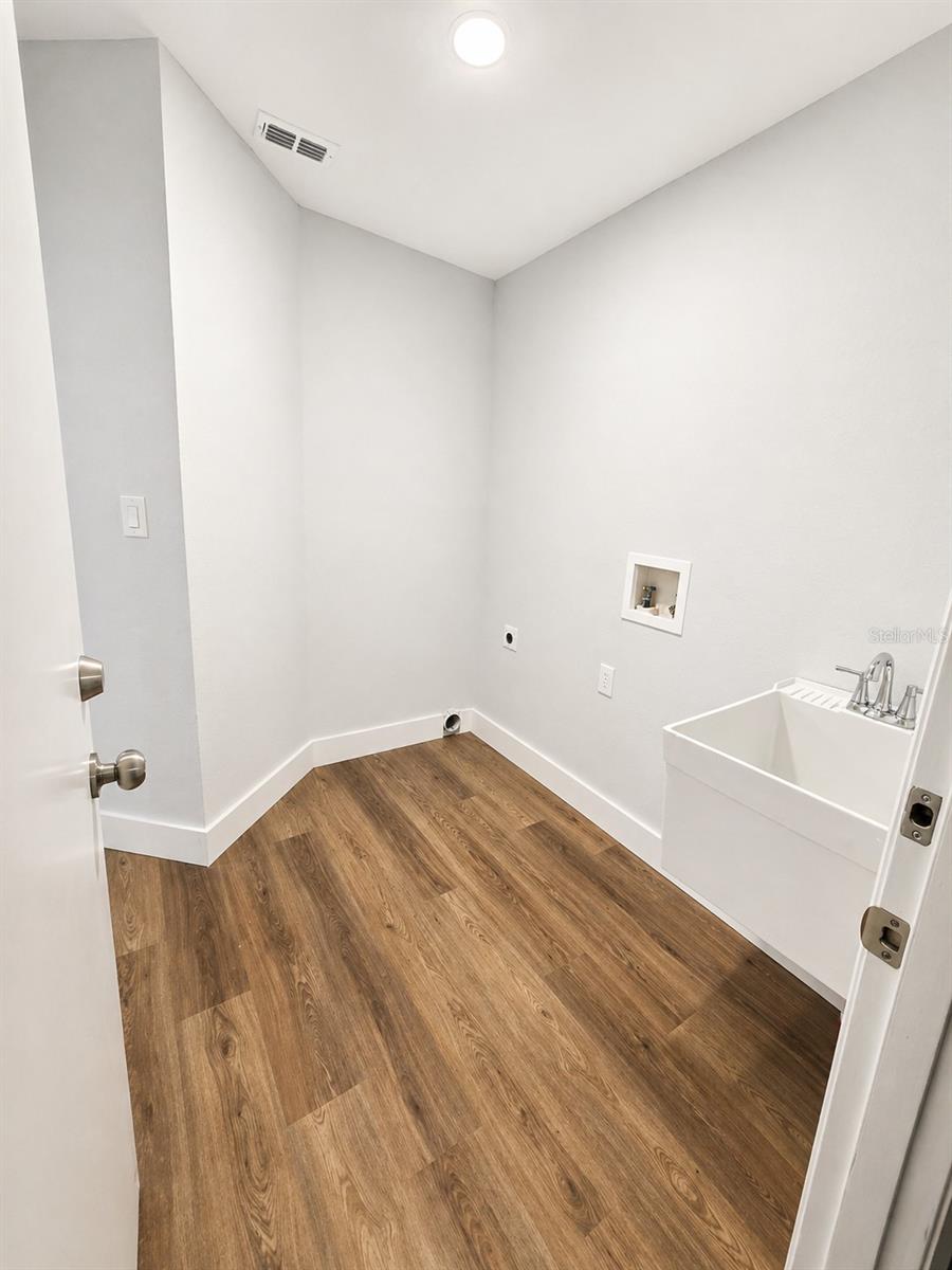 laundry room between kitchen and garage
