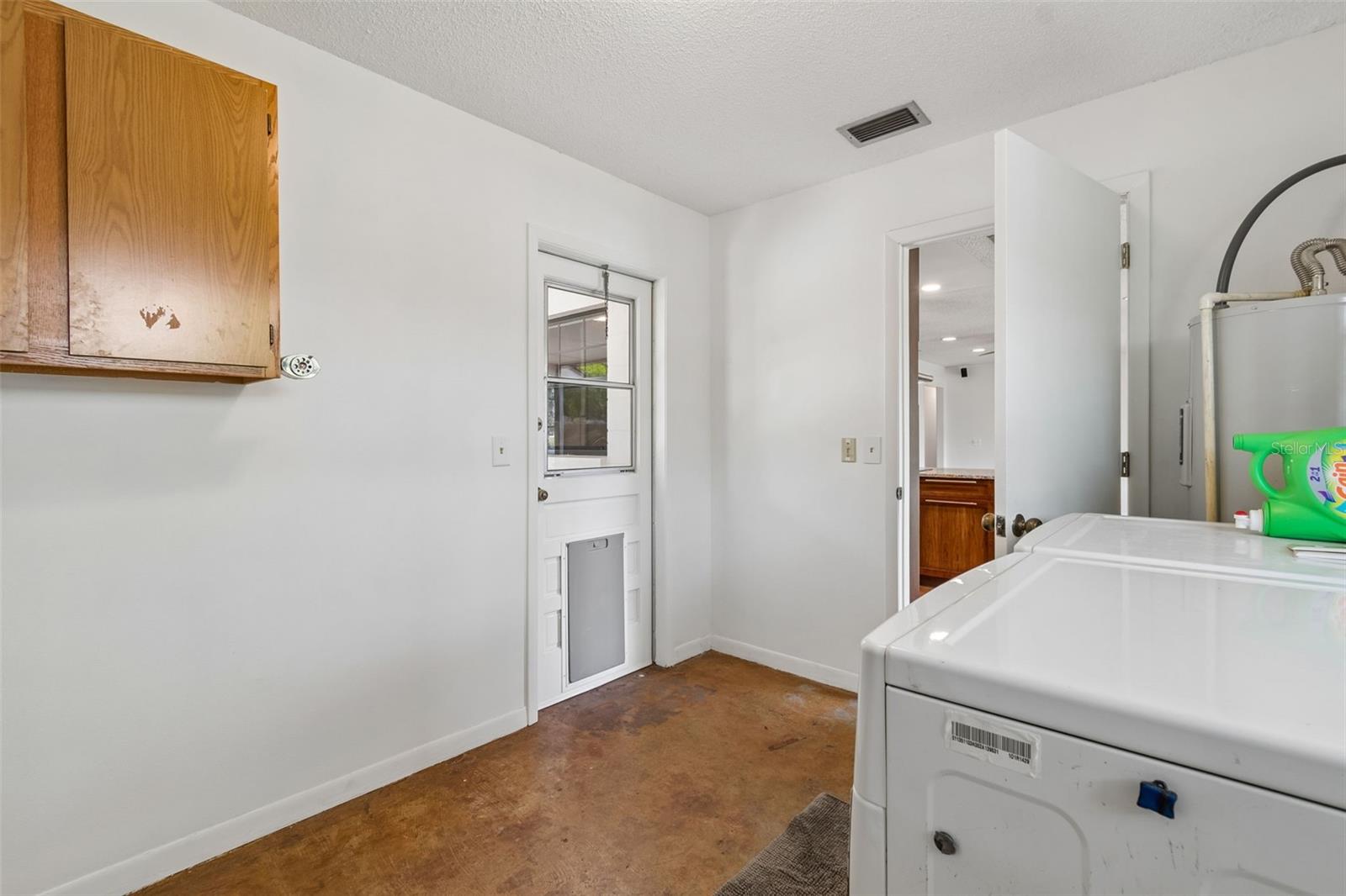 Separate laundry room to side porch and kitchen