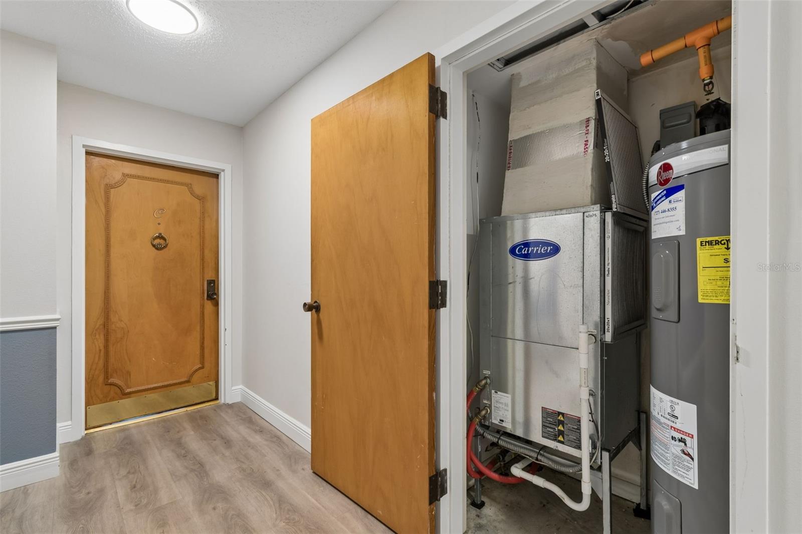 Utility closet for HVAC and water heater outside unit door